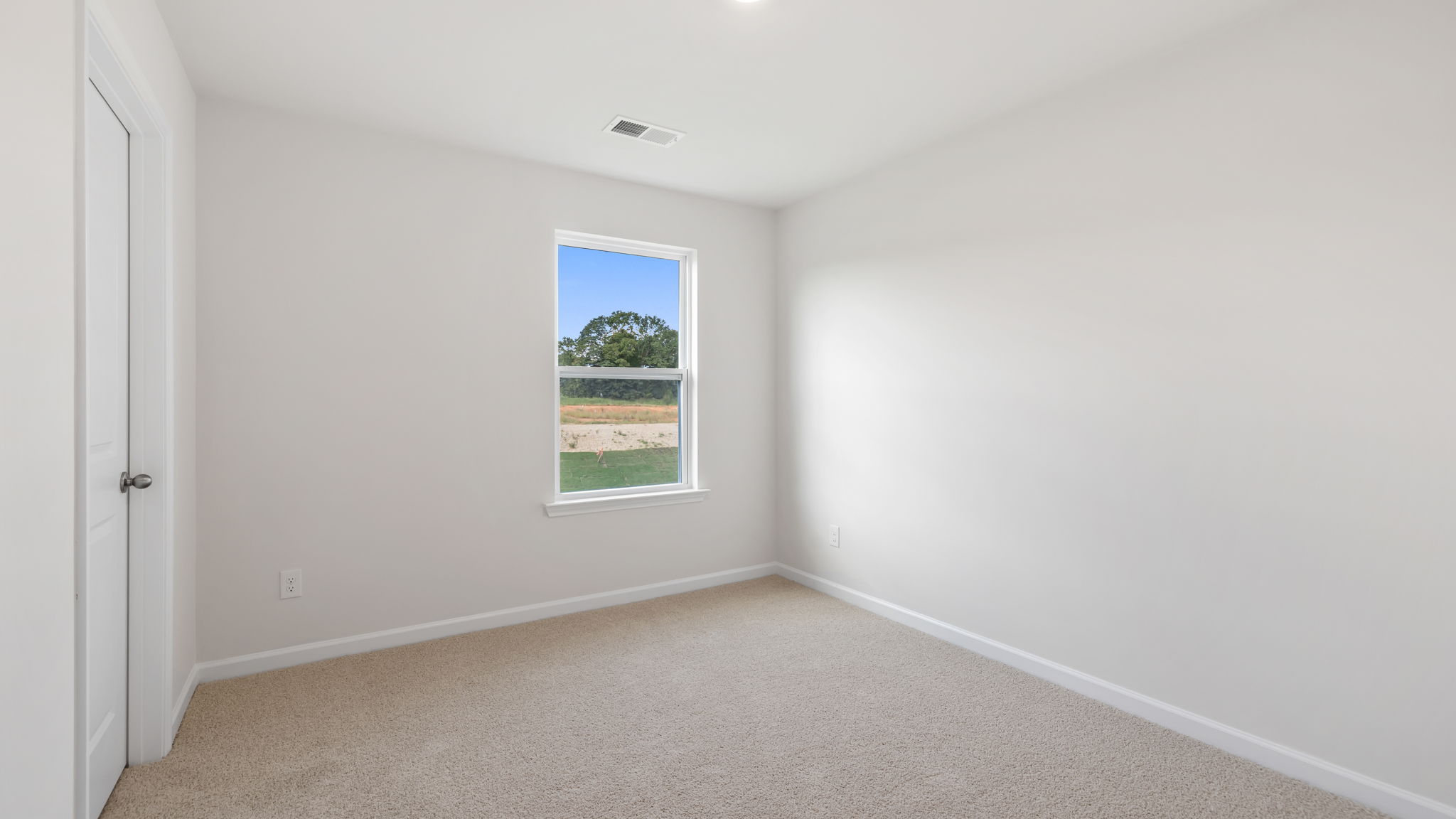 Bedroom with carpet and window.