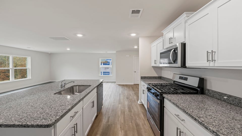 Kitchen with island and cabinets.