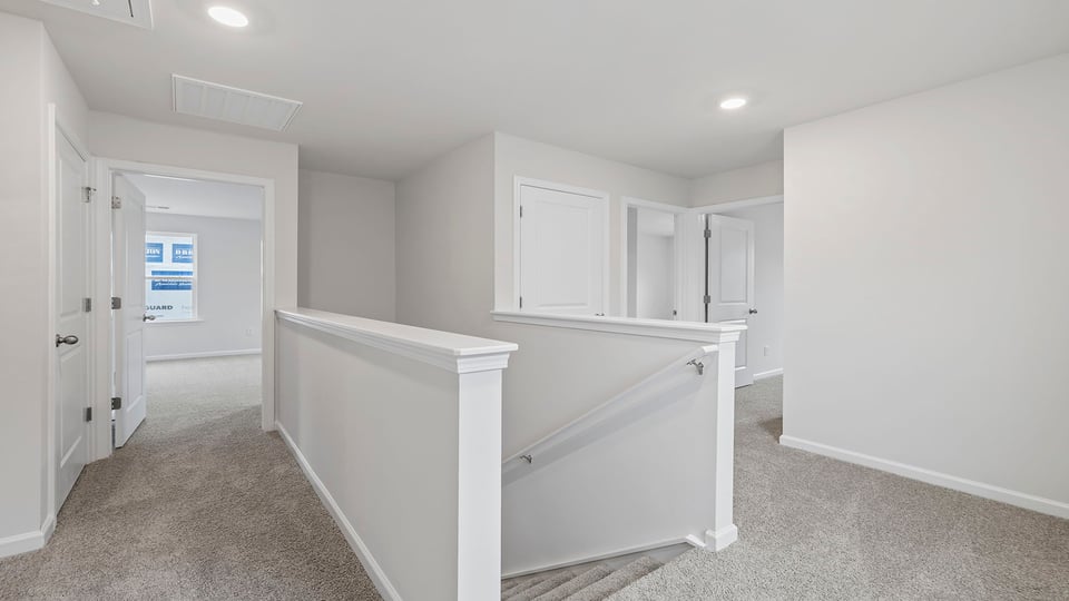 Stairs to second level with carpet.