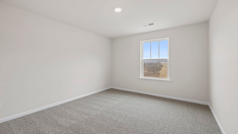 Bedroom with carpet and windows.