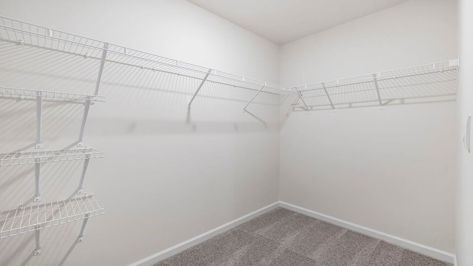 Primary closet with shelf.