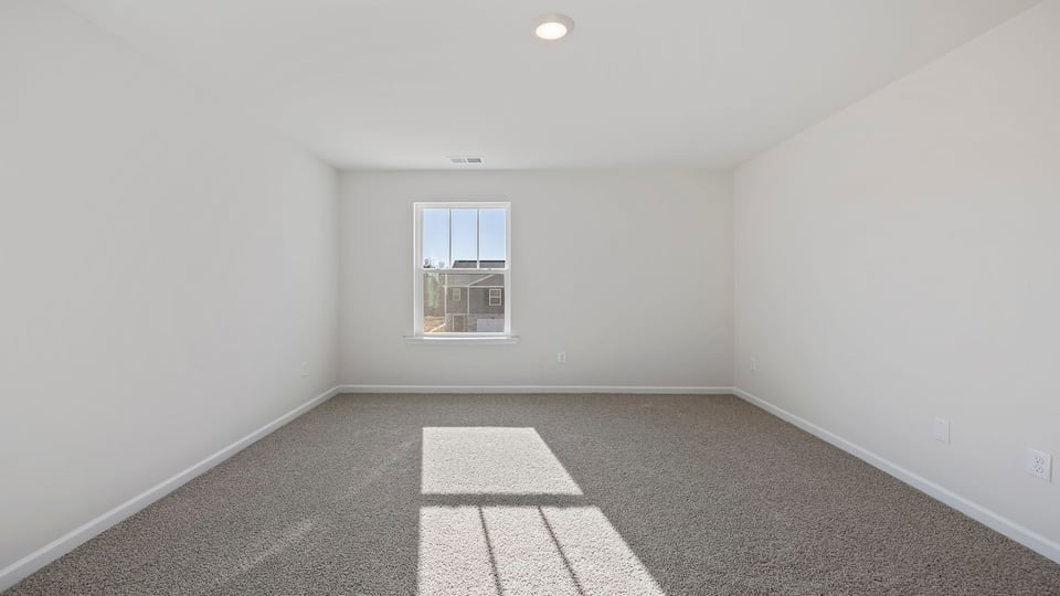 Bedroom with window and carpet.