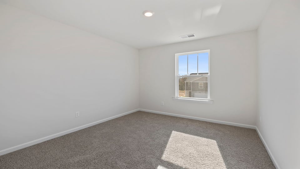 Bedroom with window and carpet.