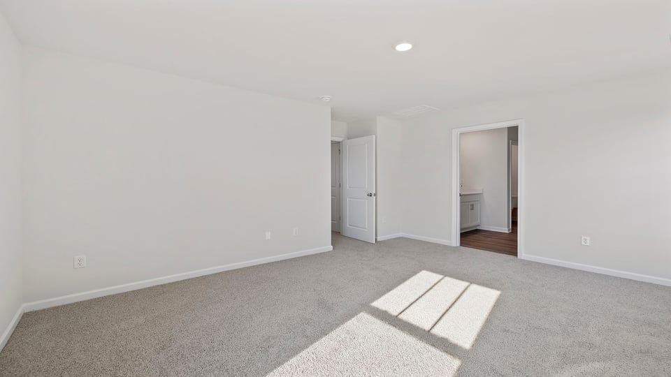 Primary bedroom with carpet.