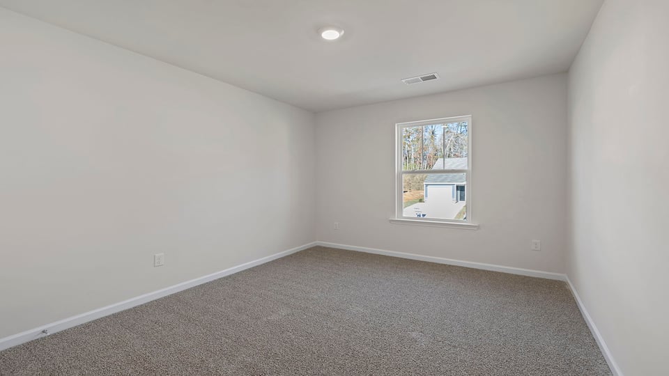 Bedroom with window and carpet.