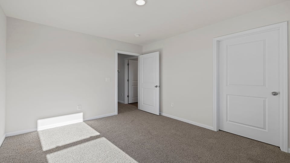 Bedroom with window and carpet.