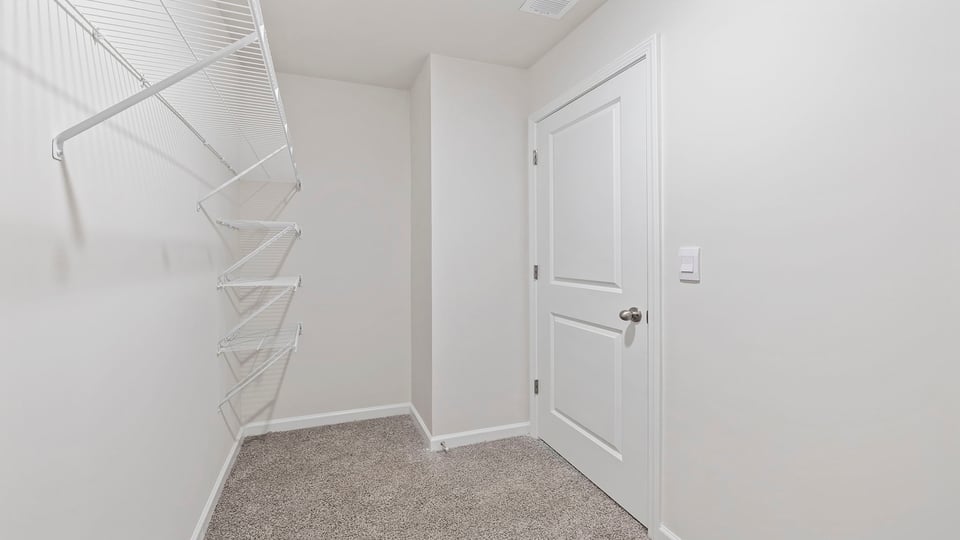 Primary bedroom walk-in closet.