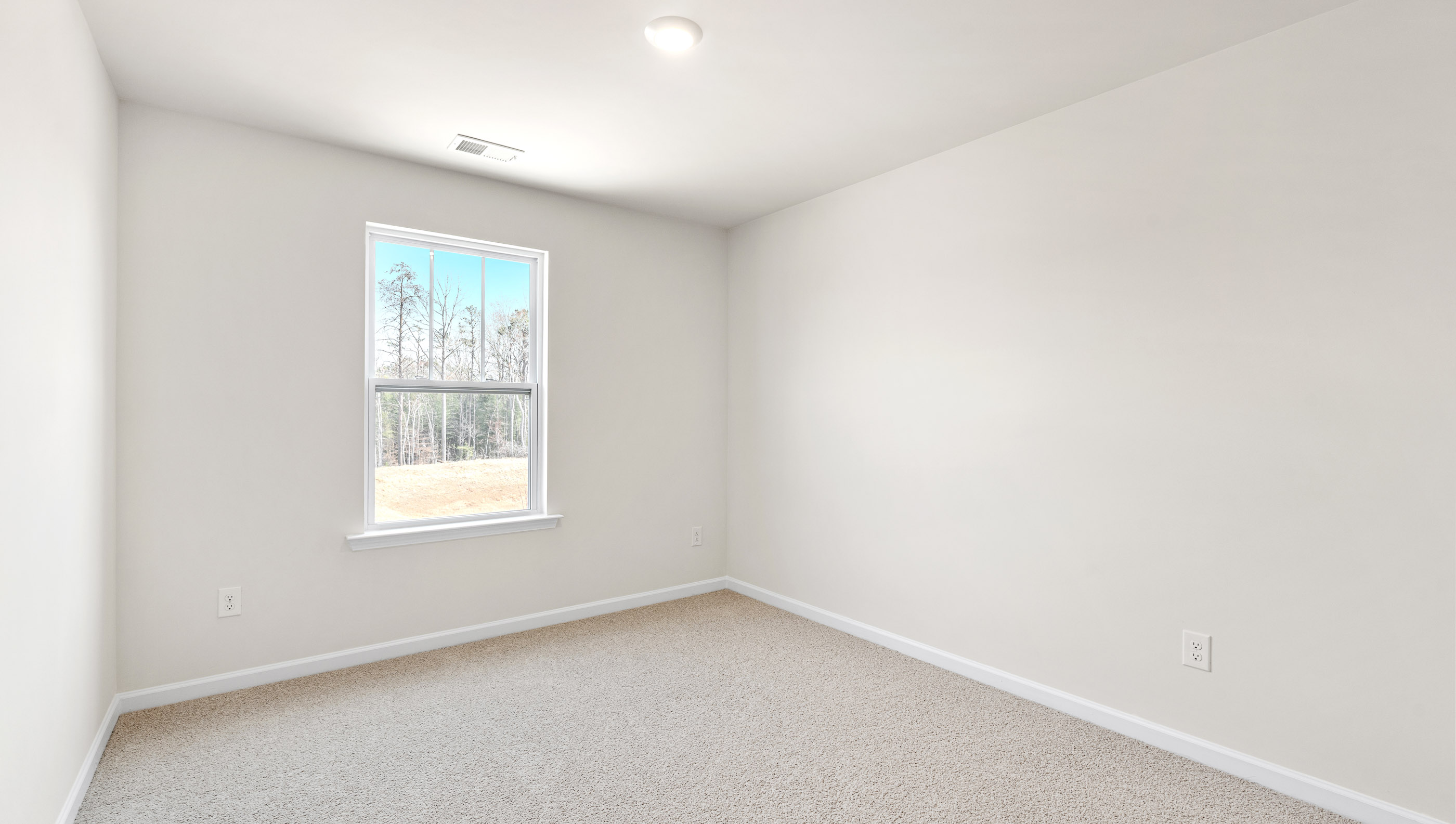 Bedroom with carpet and window.