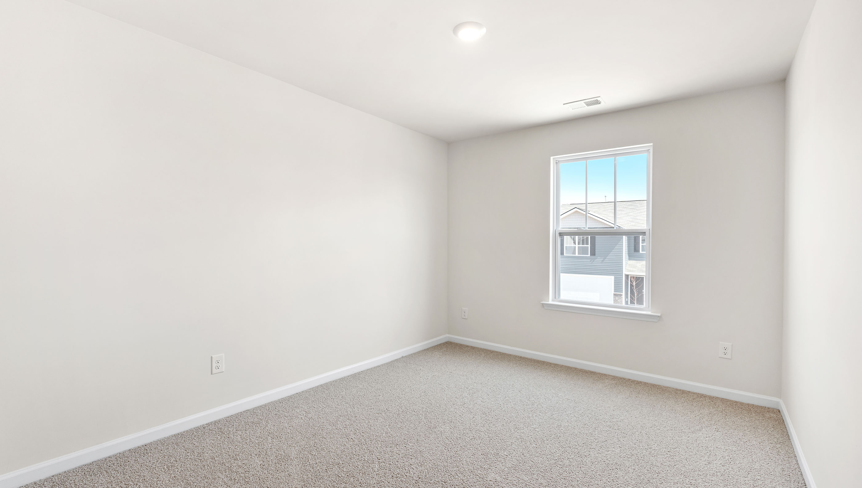 Bedroom with carpet and window.