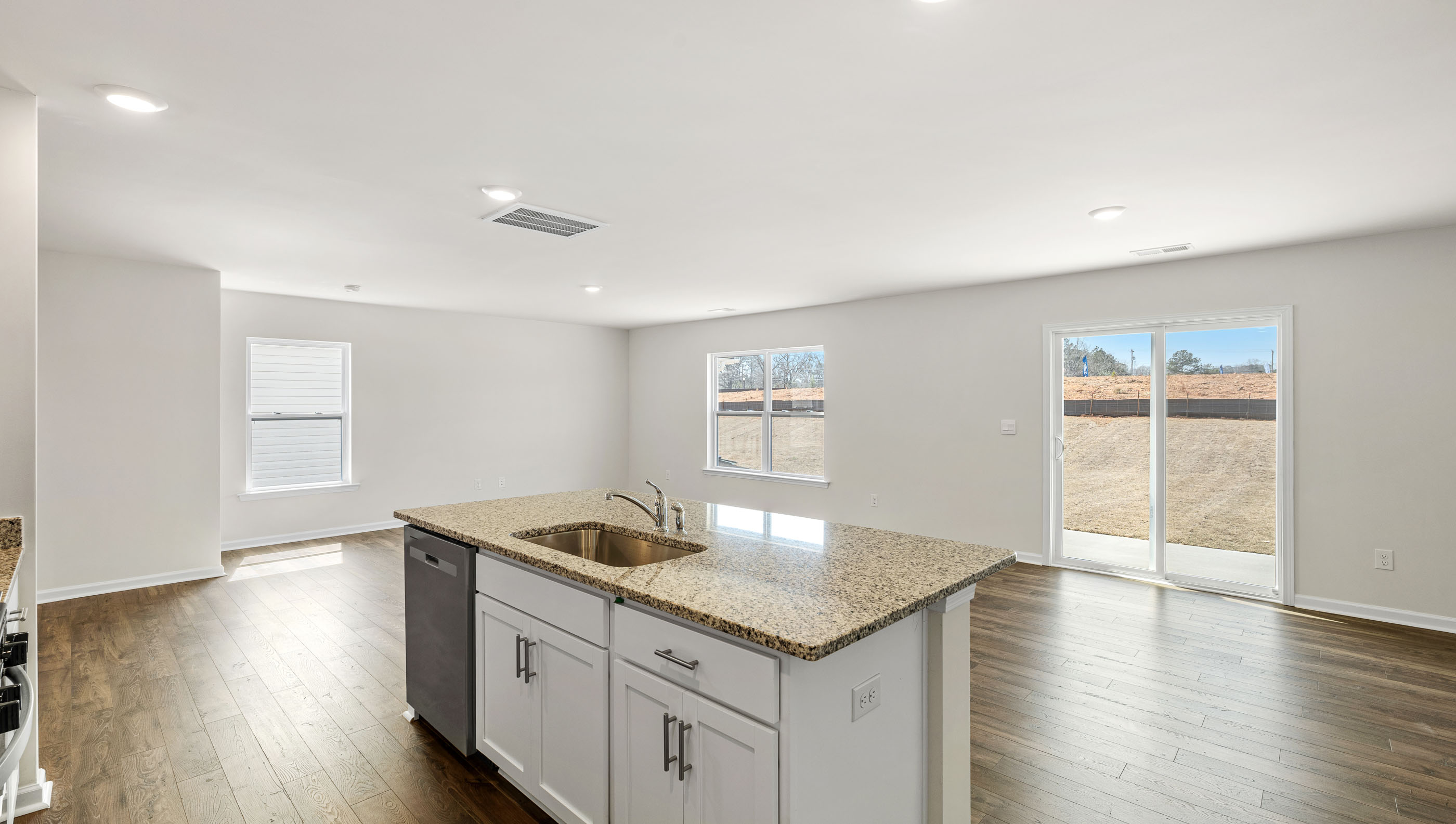Kitchen and island with granite counter tops.