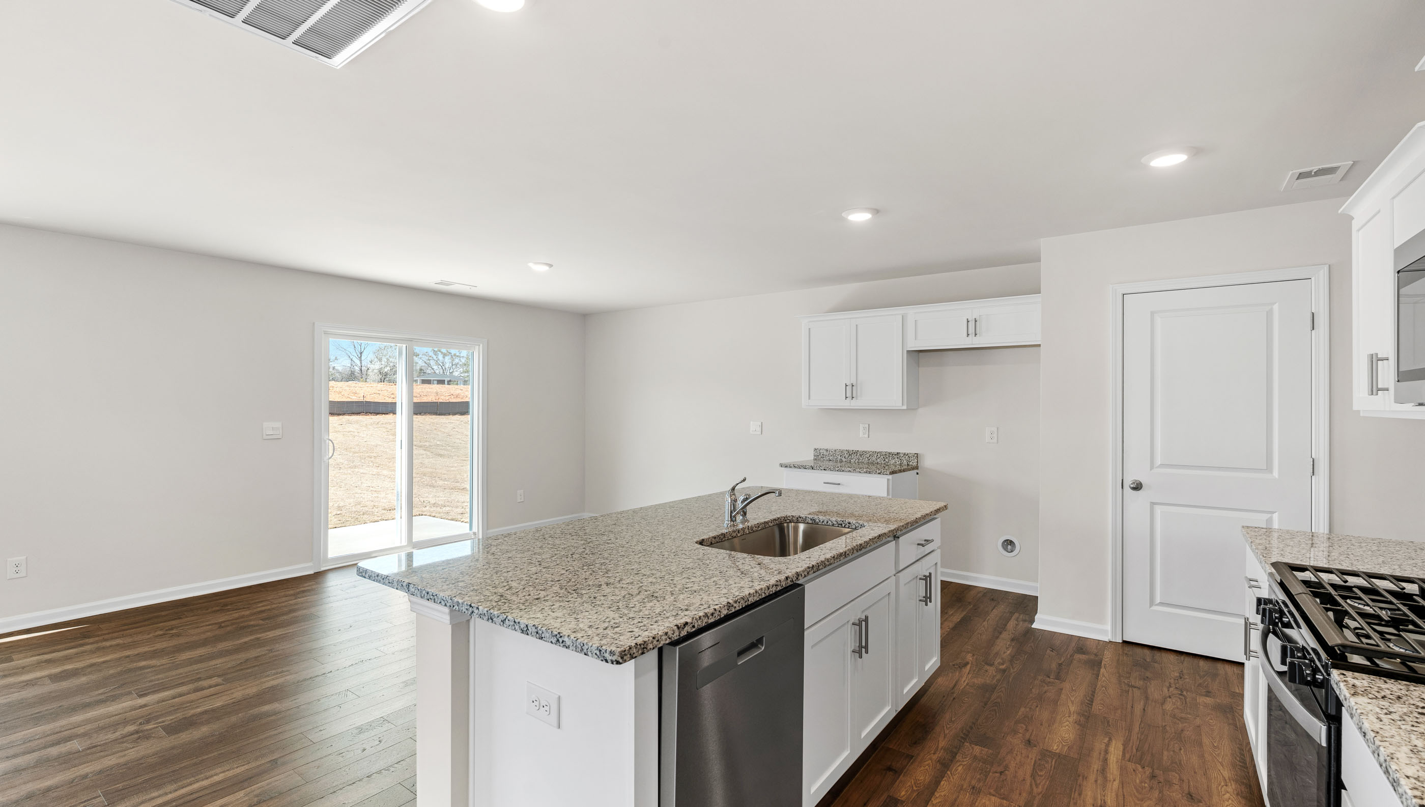 Kitchen and island with granite counter tops.