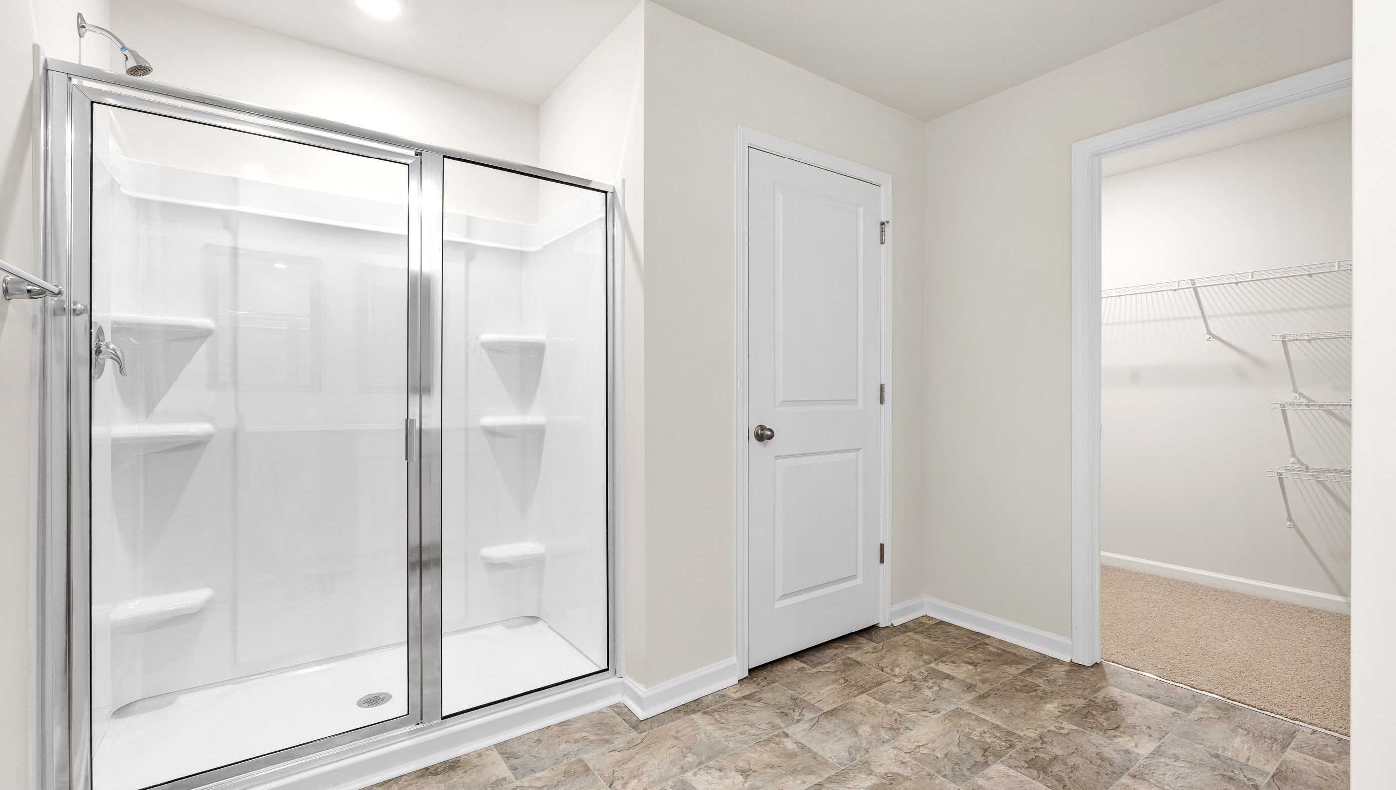 Bathroom with shower and closet.