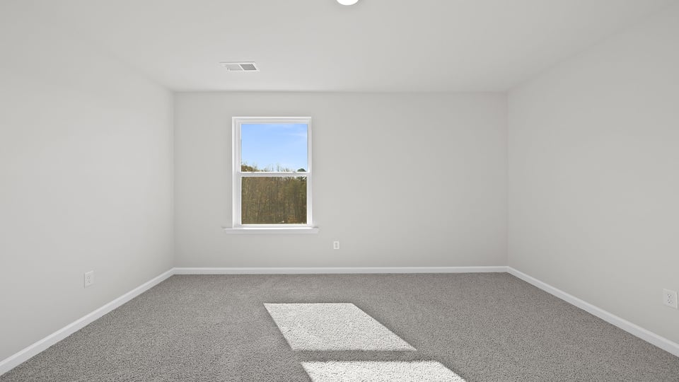Bedroom with window and carpet.