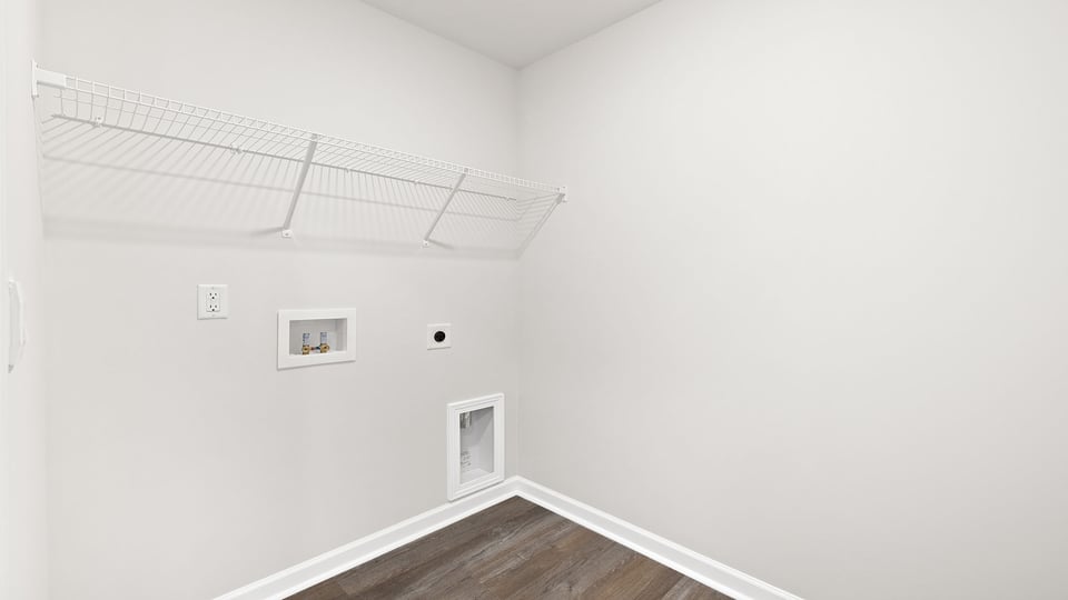 Walk-in laundry room with shelving.