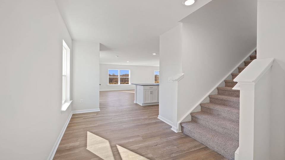View of hallway to the living areas and stairwell.