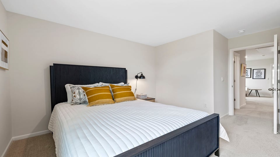 Bedroom with carpet and windows.