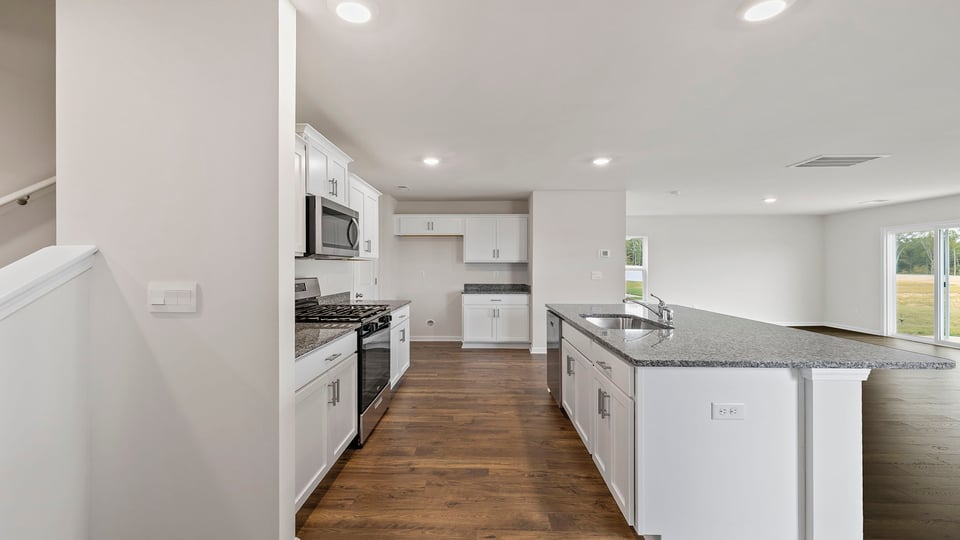 Kitchen and island with quartz countertops.