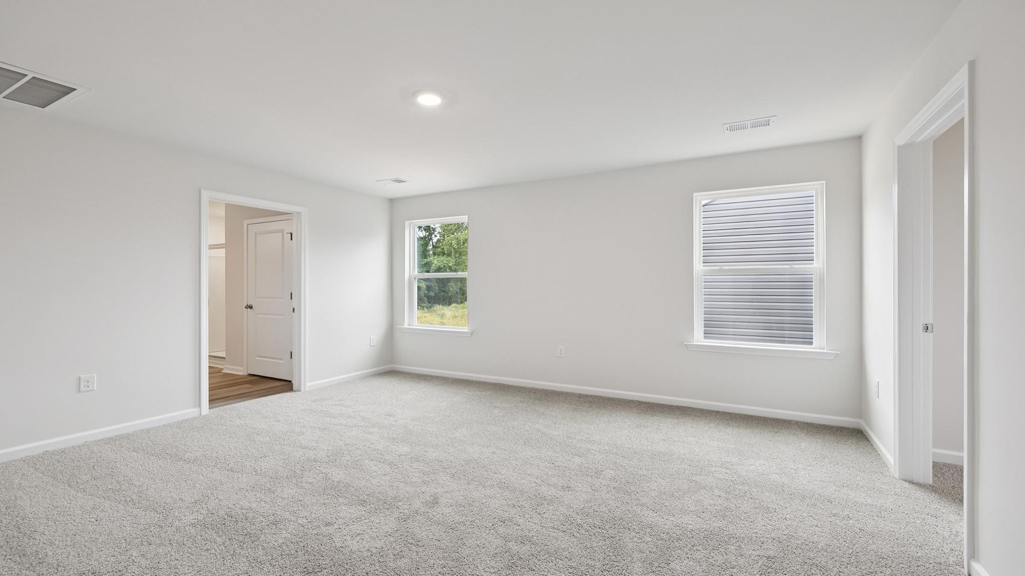Bedroom with carpet and window.