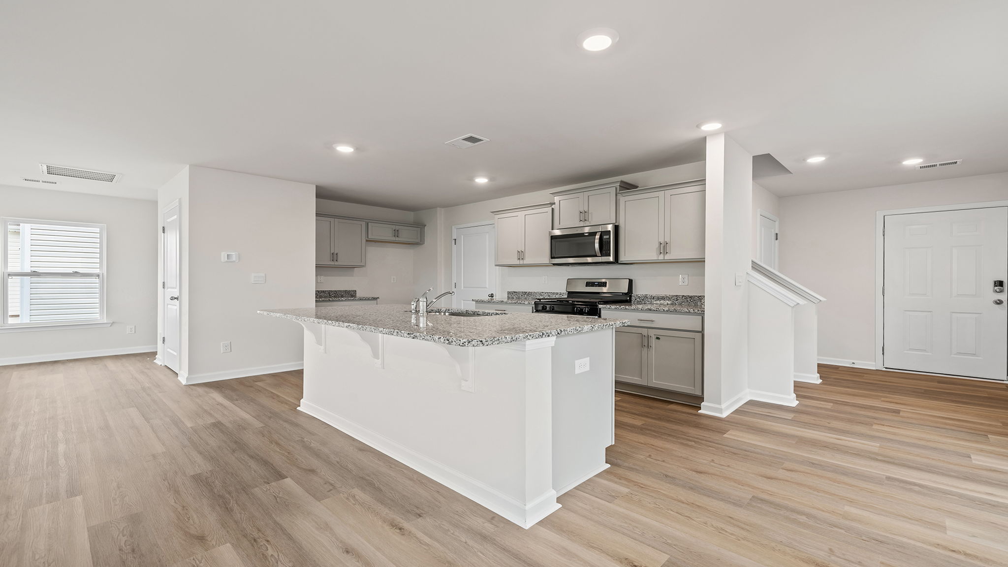 View of kitchen and hallway to the entrance.