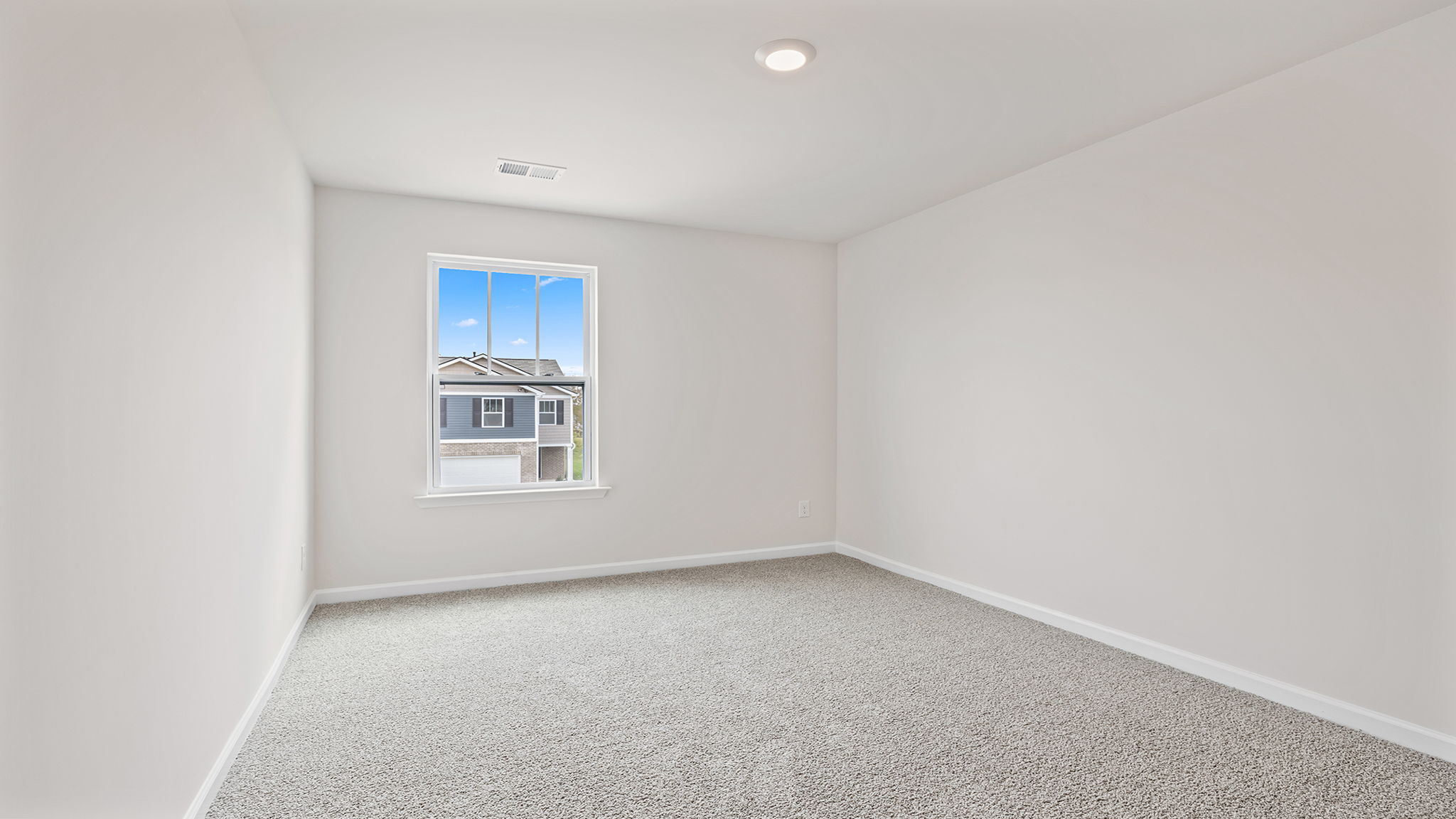 Bedroom with window and carpet.