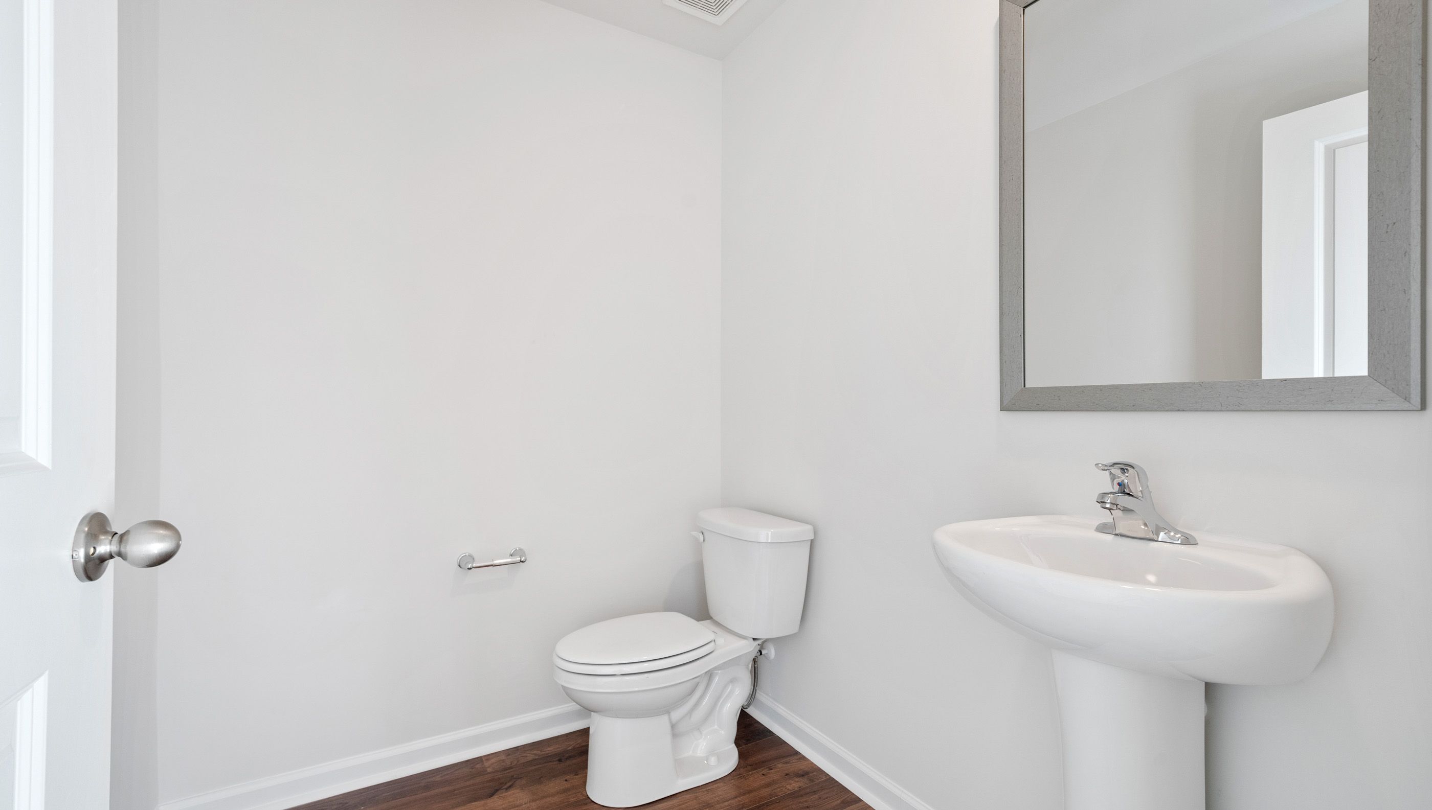 Half bathroom with mirror.