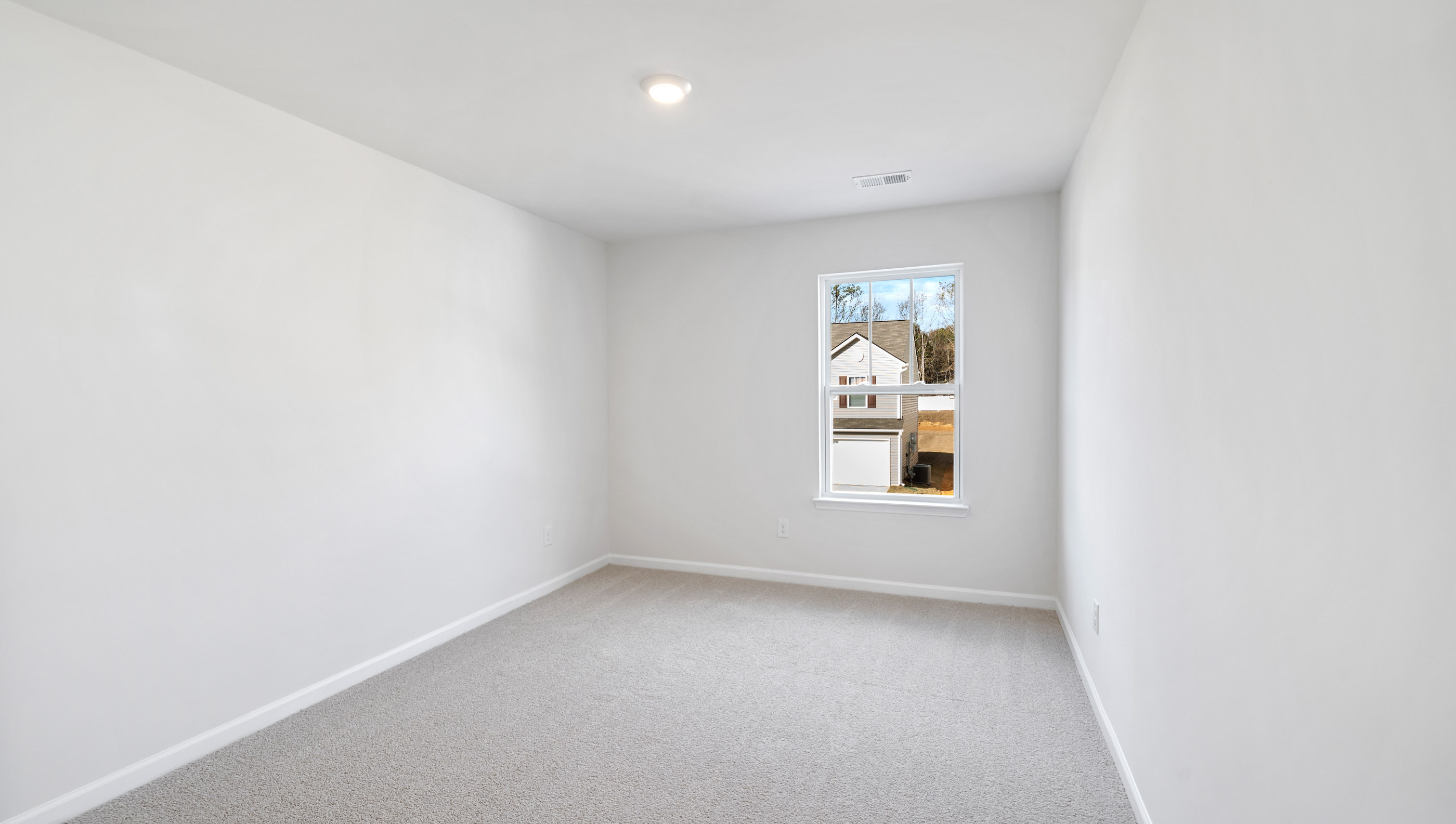 Bedroom with carpet and window.