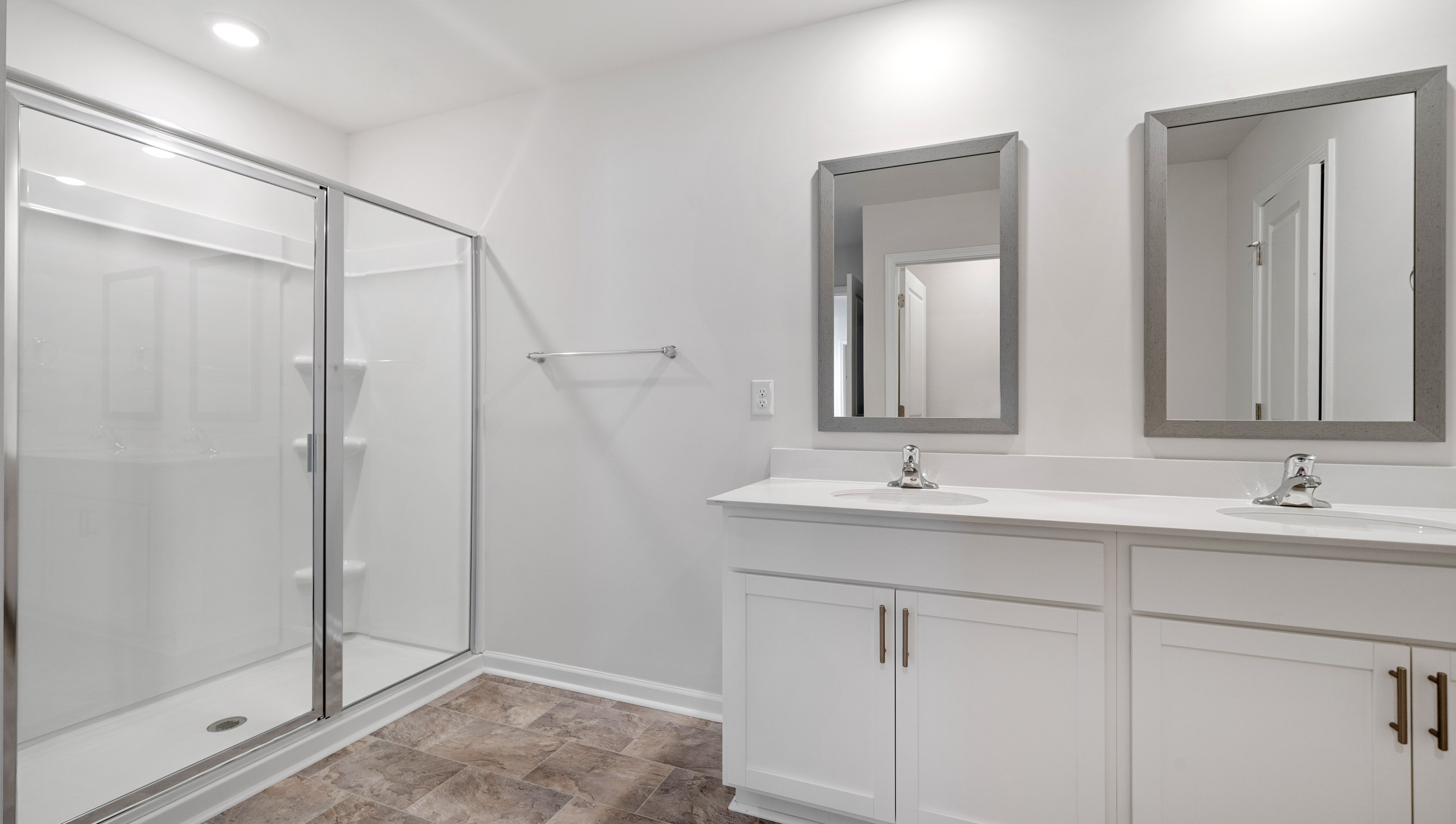Bathroom with double vanity sink and shower.