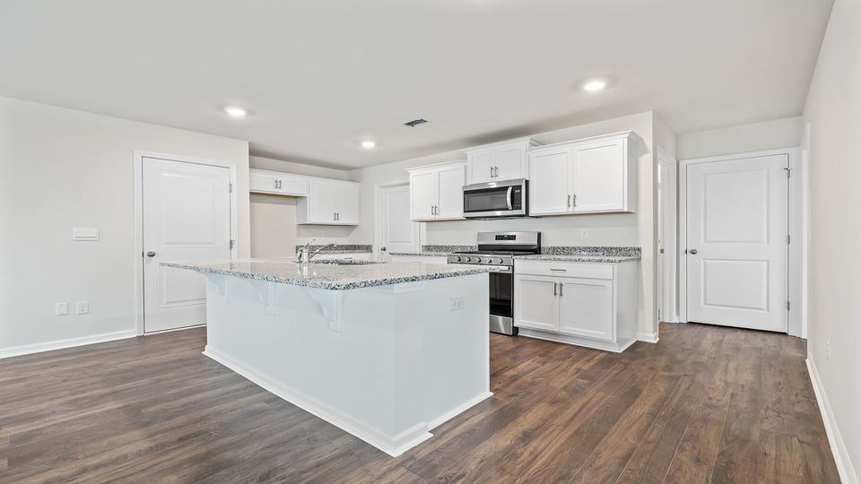 Kitchen and island with granite counter tops.