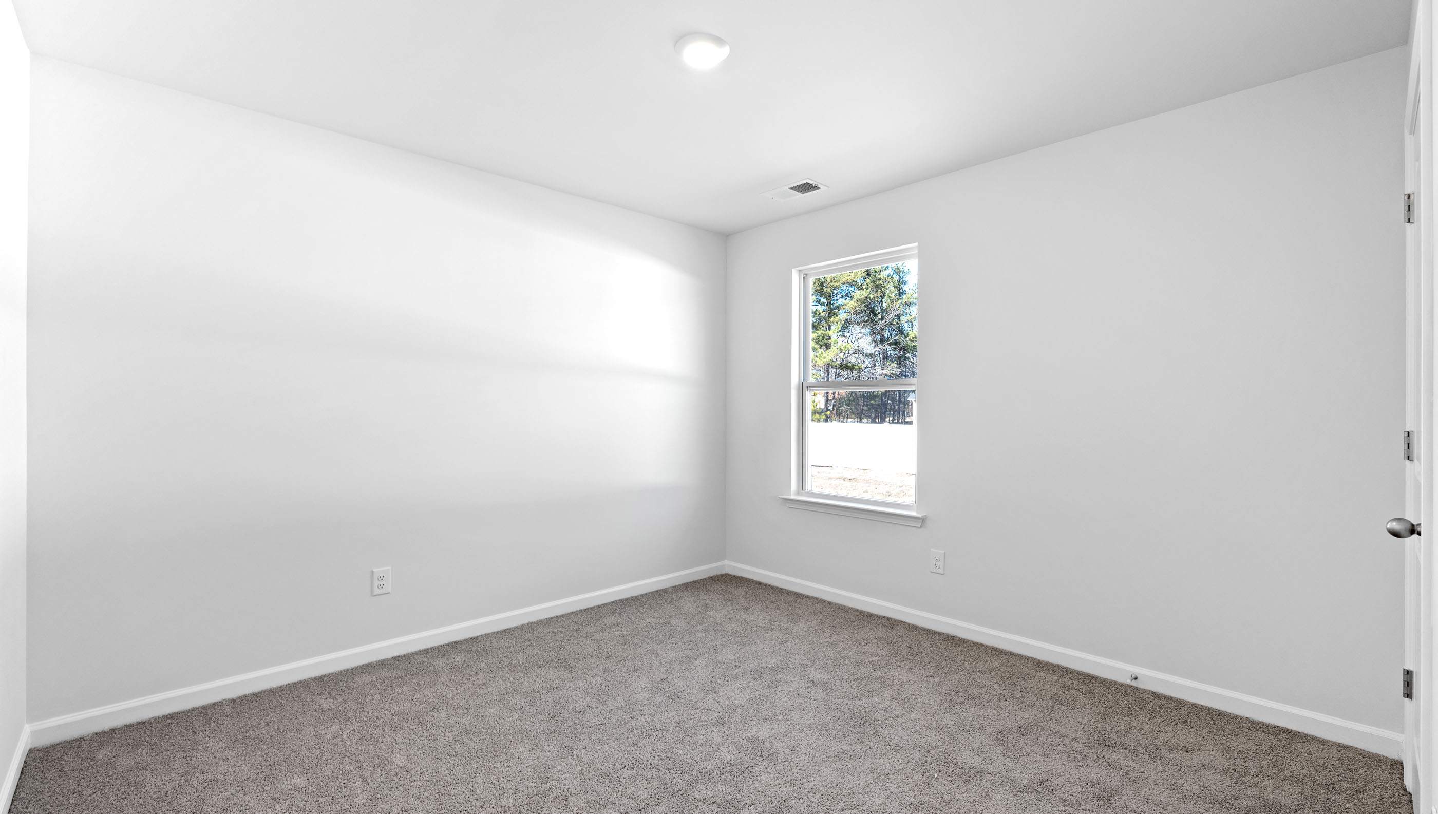 Bedroom with window and carpet.