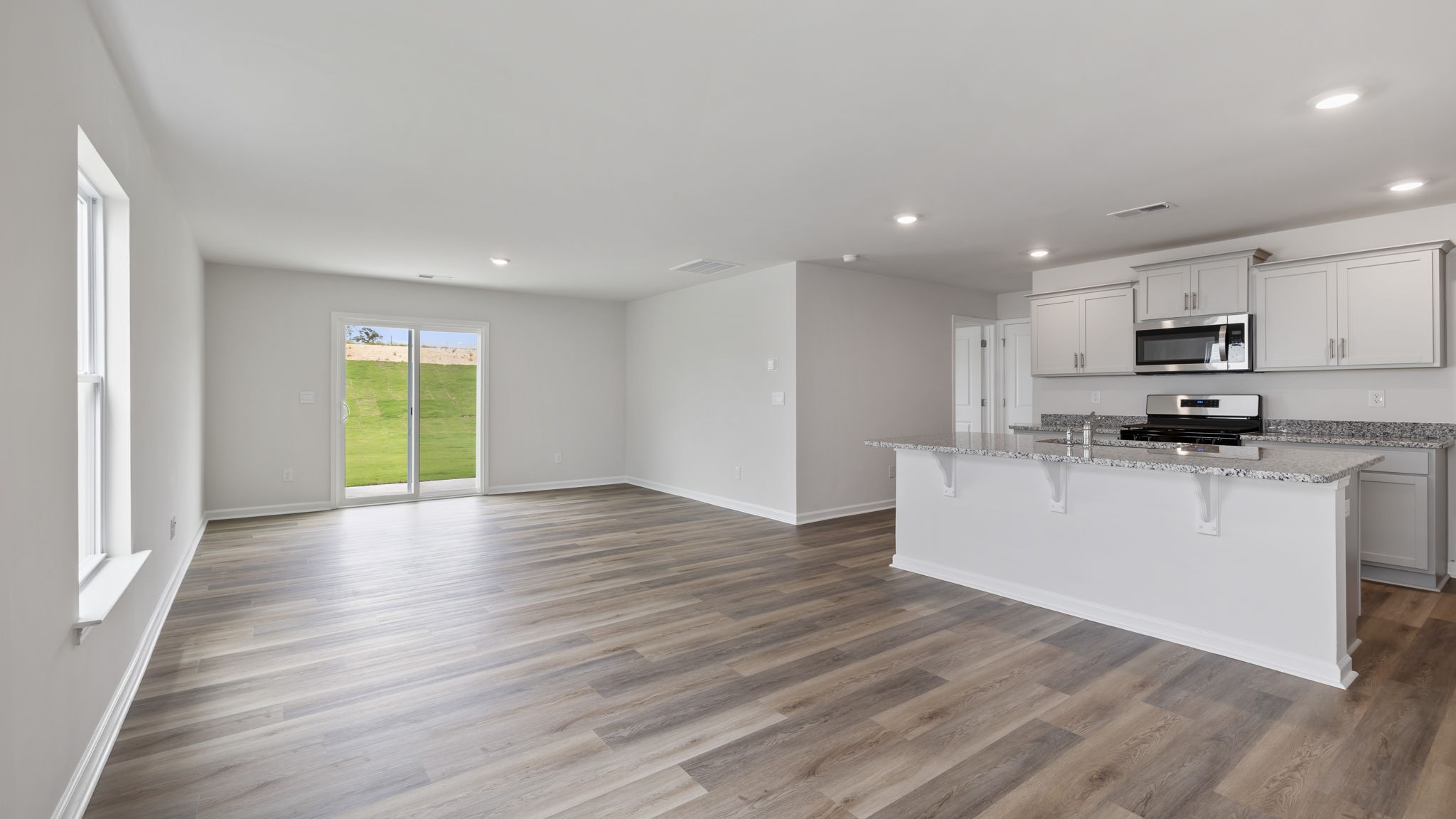 View of kitchen and dining area with door to the back yard.