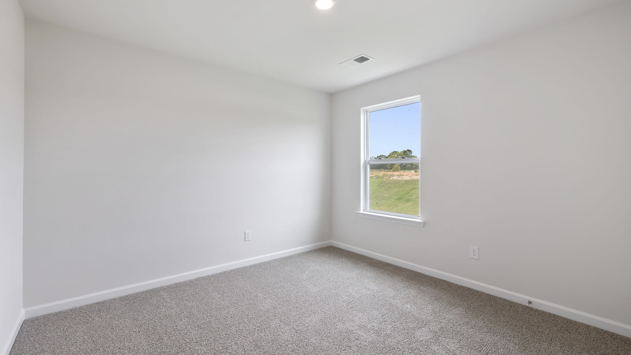 Bedroom with carpet and window.
