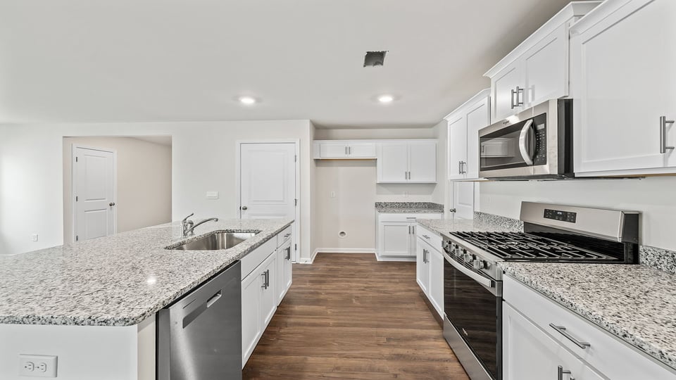 Kitchen with island and cabinets.