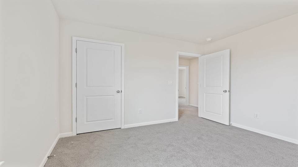 Bedroom with carpet and window.