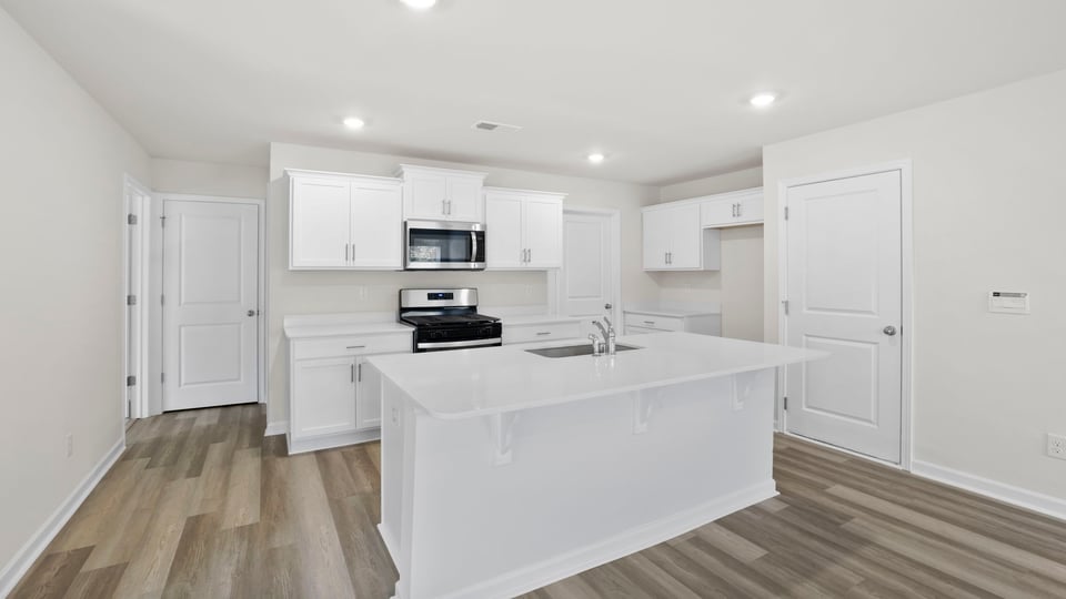 Kitchen and island with quartz countertops.