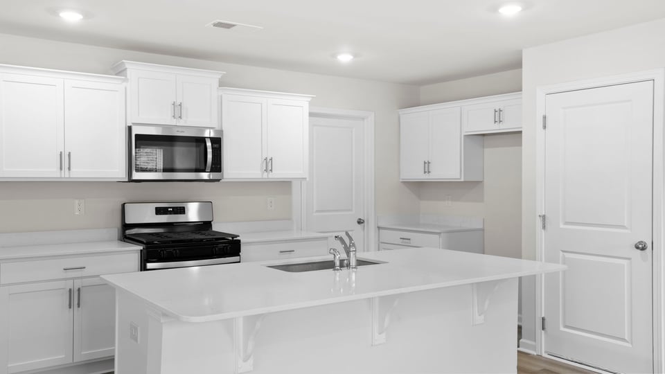 Kitchen and island with quartz countertops.
