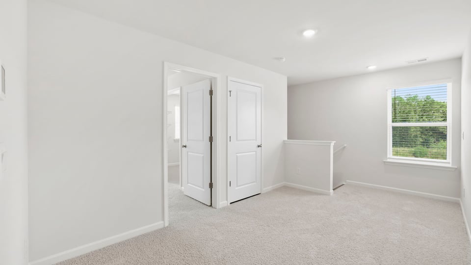 Bedroom with carpet and window.
