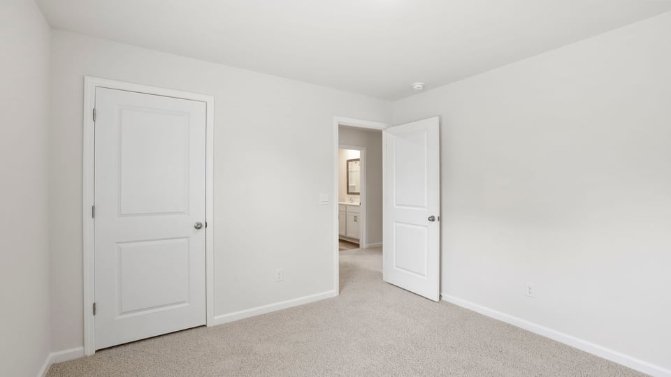 Bedroom with carpet and window.