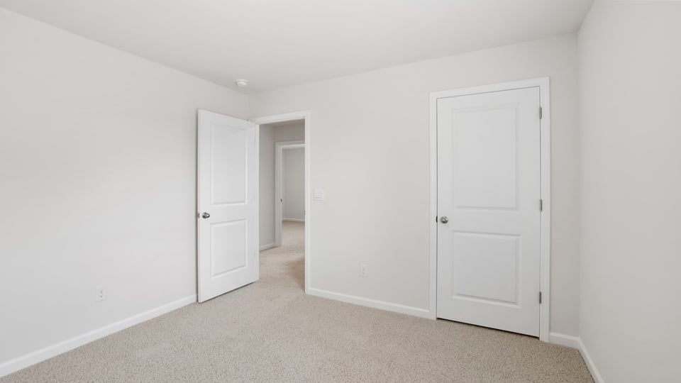 Bedroom with carpet and window.