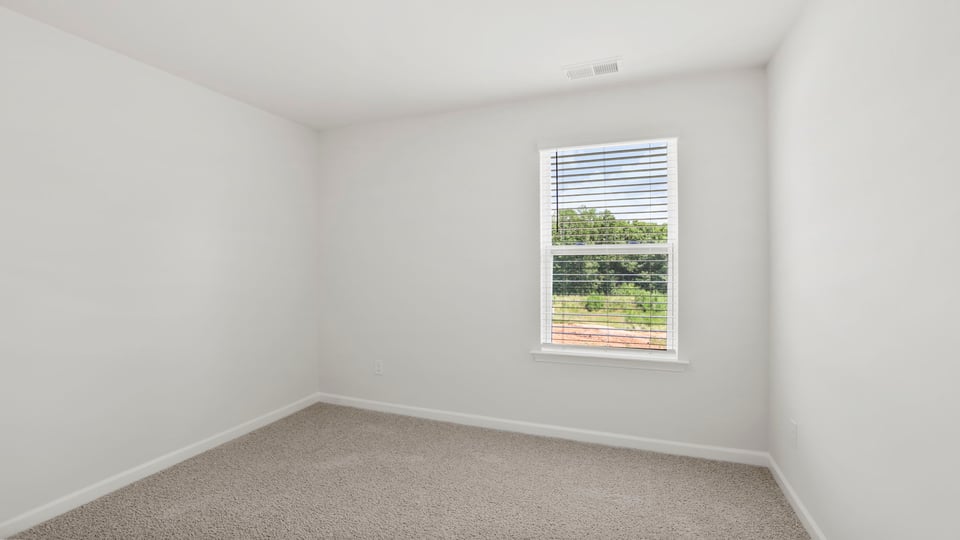 Bedroom with carpet and window.