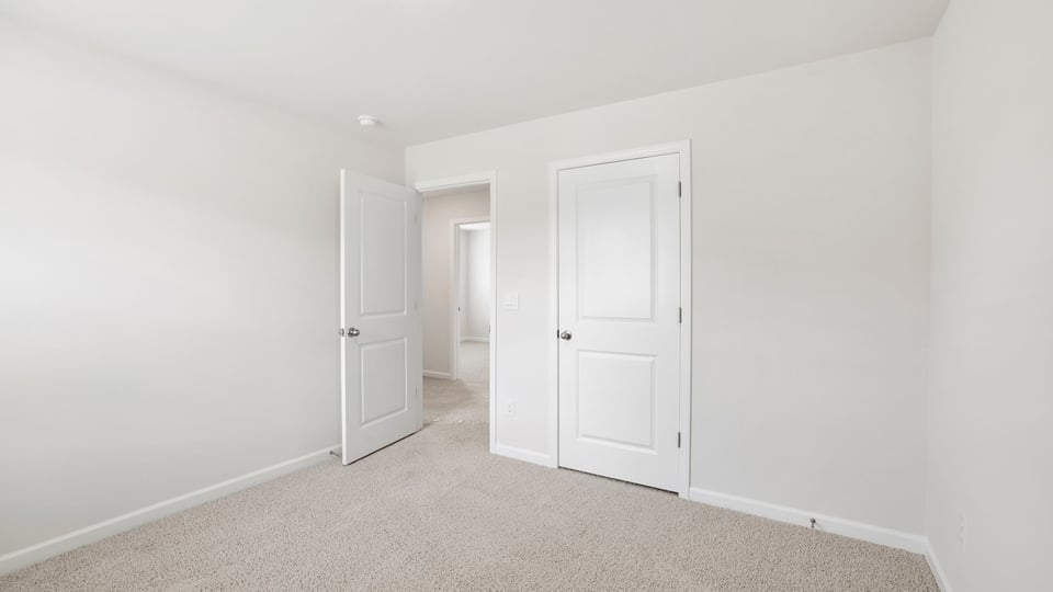 Bedroom with carpet and window.