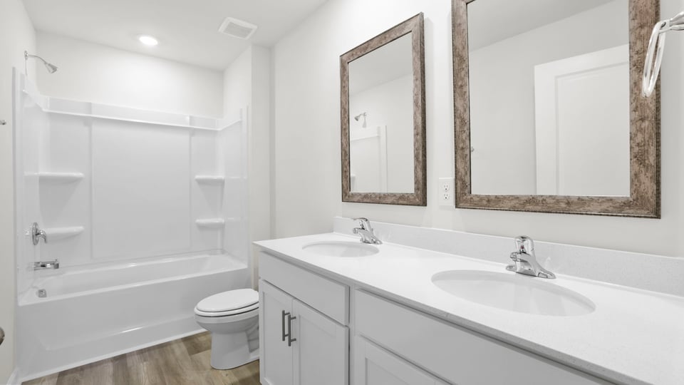 Bathroom with bathtub and double vanity sink.