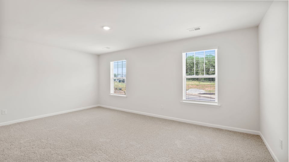 Bedroom with carpet and window.