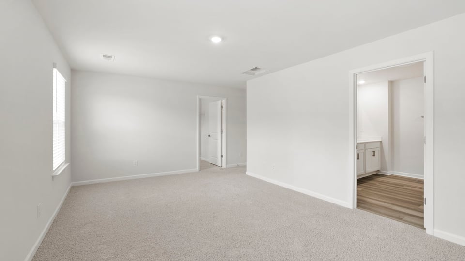 Bedroom with carpet and window.