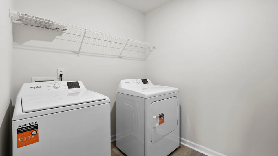Laundry room with hanging storage racks.
