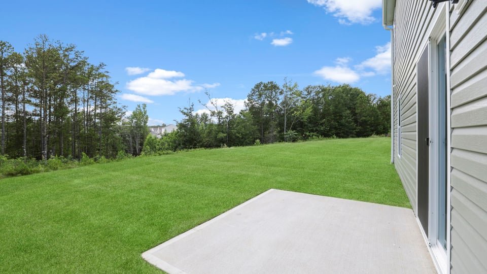 Back exterior of home with large backyard.