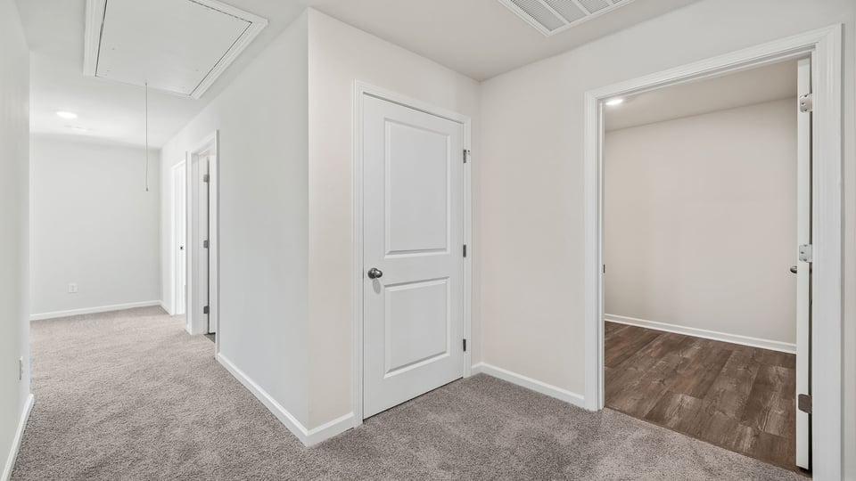 Hallway and view of the walk-in laundry room.