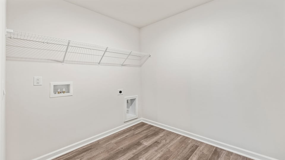 Walk-in laundry room with shelving.