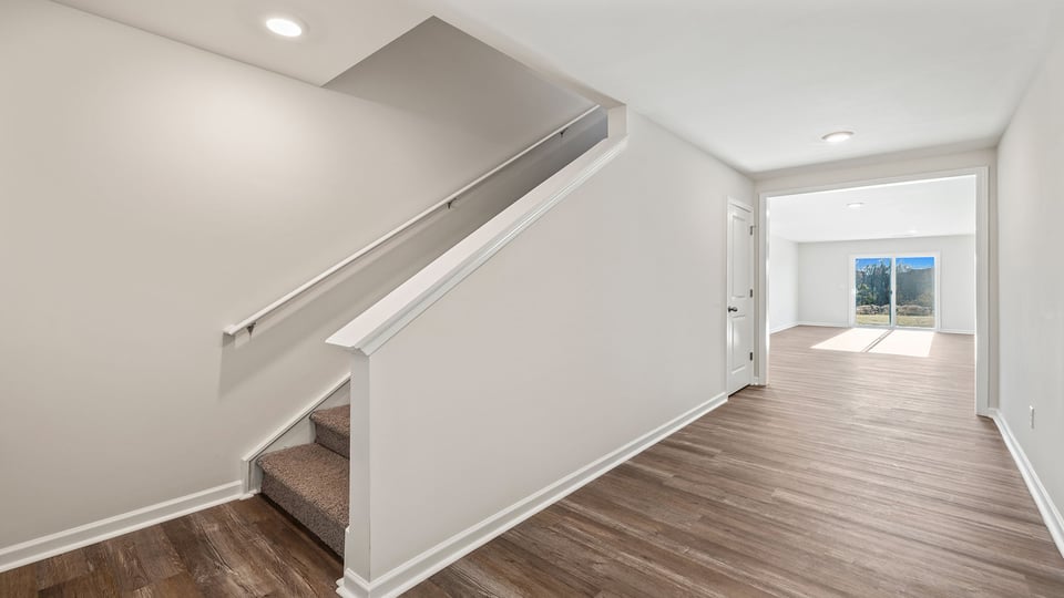 View of stairwell and hallway to family room.