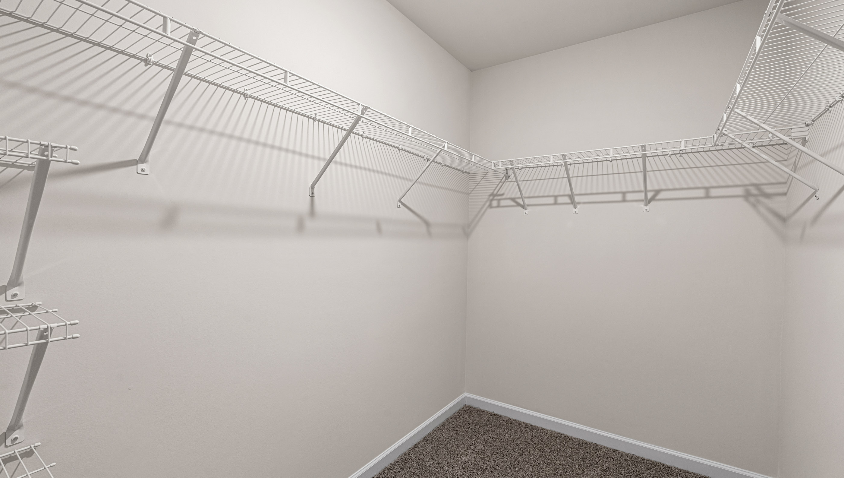 Closet with hanging storage shelves.