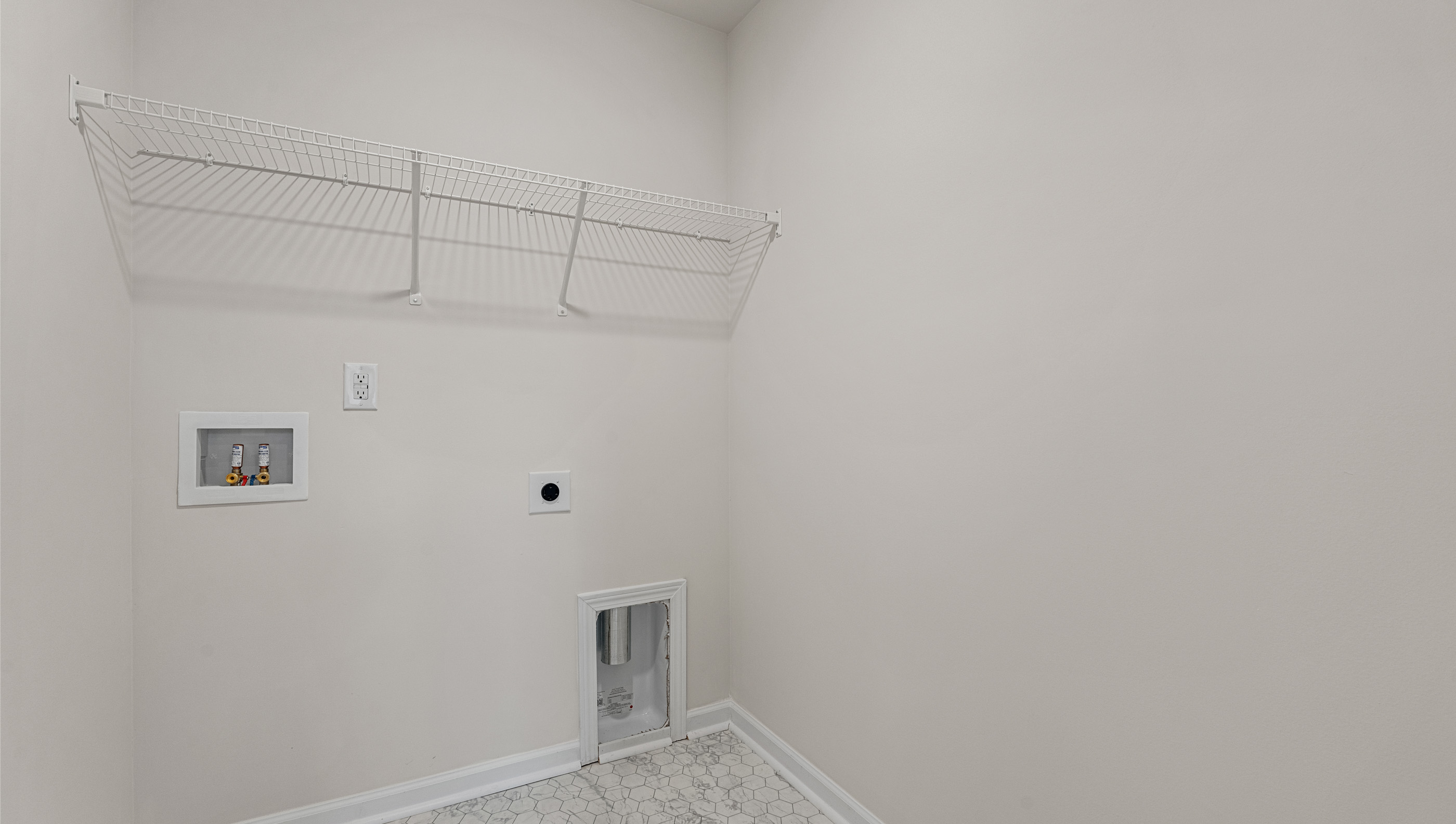 Laundry room with hanging storage racks.